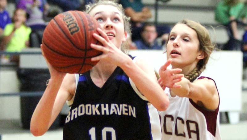 Daily Leader / Sherylyn Evans / Brookhaven Academy's Edie Riley (10) prepares to take a shot while WCCA's Bailey Devers (33) tries to block the shot Tuesday night.