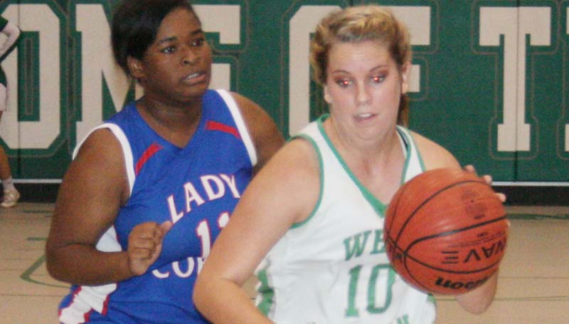 Daily Leader / Marty Albright / West Lincoln's senior guard Layton Sills (10) drives past Wesson's Carnesha Green (11) in girls' action.