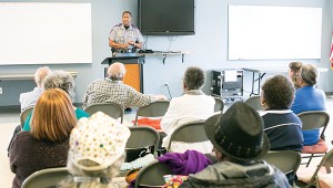 Photo by Kaitlin Mullins Lt. Charles Coleman H-1, MHP Troop H, spoke to a group of seniors about the dangers of fraud at the Jimmy Furlow Senior Center on Tuesday. Coleman talked about the importance of checking the credibility of charities during the holiday season, when many false charities are preying on the kindness of others. Coleman said necessary precautions include checking the credibility of any company one encounters, and also not giving away any personal information — especially medical — over the phone. Medicaid fraud, he warned, can happen to anyone and all need to be aware and protective of their information.