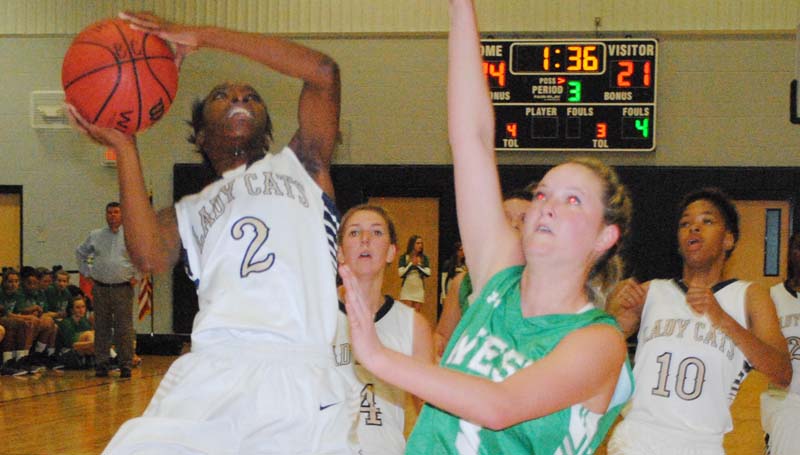Daily Leader / Marty Albright / Bogue Chitto's Zariah Matthew (2) attempts a tough shot under the basket as West Lincoln's Alli Mullins (3) hustles in to defend the shot.