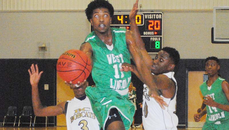 Daily Leader / Marty Albright / West Lincoln's Keshaun London (11) glides through the lane for a layup Thursday night as Bogue Chitto defenders La'Fredrick Dillon (3) and Tyler Brumfield (10) try to deny the play.
