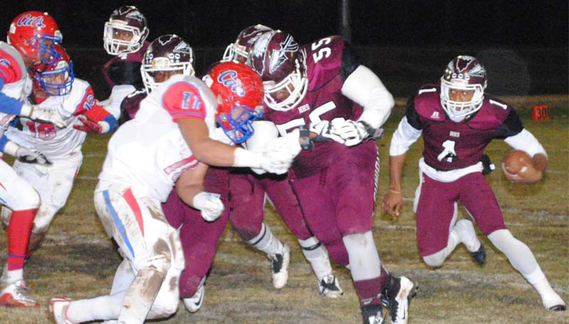 Daily Leader / Marty Albright / Hazlehurst quarterback Ladarrious Williams (1) looks for an open gap while his lead blocker Lechris Hood (55) clears a path Friday night against Forest.
