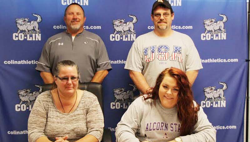 Co-Lin Media / Natalie Davis / Copiah-Lincoln Community College (Miss.) catcher Jessica Crum of Dutchtown, Louisiana (seated right) has signed a letter of intent to play at Alcorn State University (Miss.). Crum led the Lady Wolves in batting average (.480), hits (49), RBIs (59), walks (58) and tied for the team lead in doubles (8). She broke the single season home run record hitting 16 in 2015. The previous record was 10 home runs in a season. Crum was named National Junior College Athletic Association (NJCAA) All-Region 23 and Mississippi Association of Community and Junior College (MACJC) First Team All-State as a freshman. She was named the NJCAA's National Player of the Week following the opening week of the 2015 season when she hit two home runs and had 14 RBIs. Pictured with Crum are her parents, Diane and Tim Crum (standing right) and Lady Wolves head coach Allen Kent.