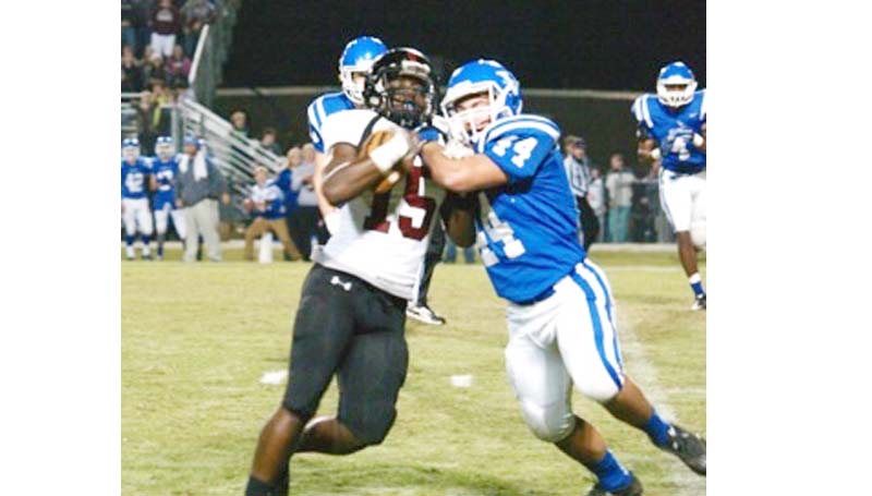 Daily Leader / Jana Harp / Lawrence County Marcus Atterberry fights off an Vancleave defender for more yards Friday night.