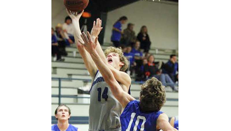 Daily Leader / Sherylyn Evans / Brookhaven Academy's Dylan Winborne (14) drives in for a lay up against Presbyterian Christian's Alex Essary (10) Saturday.