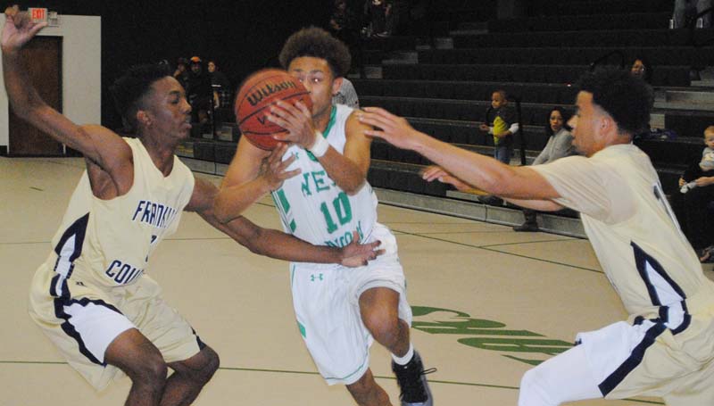 Daily Leader / Marty Albright / West Lincoln's Ronnie Edwards (10) drives to the basket while being double-teamed by Franklin County's Kel Covington (1) and Tony Gibbs (13) Tuesday night at Jack Case Gymnasium.