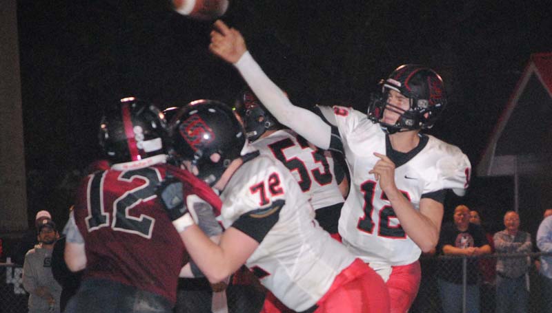 Daily Leader / Marty Albright / Lawrence County defensive lineman Will Thurman (12) battles against St. Stanislaus' tackle Erik Handshoe (72) to break up the pass from quarterback Myles Brennan Friday night.