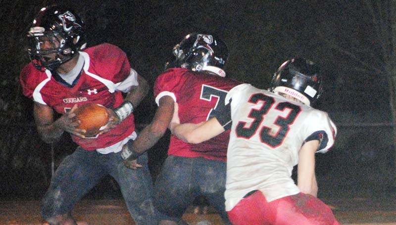 Daily Leader / Marty Albright / Lawrence County quarterback Charl'Tez Nunnery (5) fakes a handoff to Josh Knight (7) in Friday night action against St. Stanislaus.