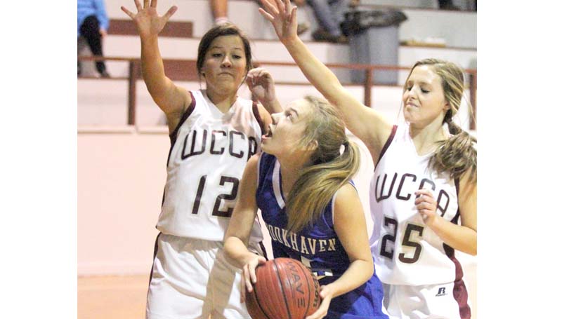 Daily Leader / Sherylyn Evans / Brookhaven Academy's Sissy Byrd battles in the paint while being double team by two Wilkinson County Christian Academy defenders Thursday night.
