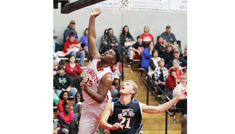 Daily Leader / Amy Rhoads / Loyd Star Avery Leggett (25) scores a layup over Bogue Chitto's Brandon McKenzie (21) Friday night.