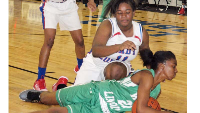 Daily Leader / Tracy Fischer / West Lincoln Demesha Deer (21) looks to call a timeout on the floor before Wesson's Carnesha Green (11) could reach over to get a jump ball call Friday night.