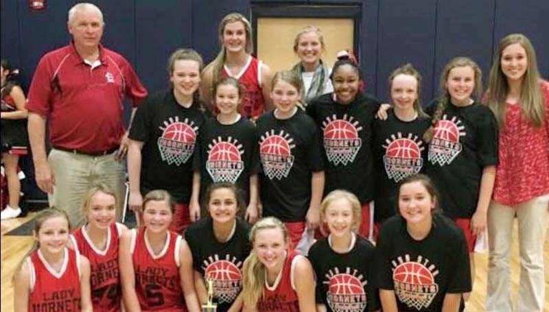 Daily Leader / Photo sumitted / Loyd Star coach Gene Britt and his Lady Hornets won the Lincoln County girls junior high tournament trophy after defeating the Bogue Chitto Lady Bobcats 21-18 Monday night.