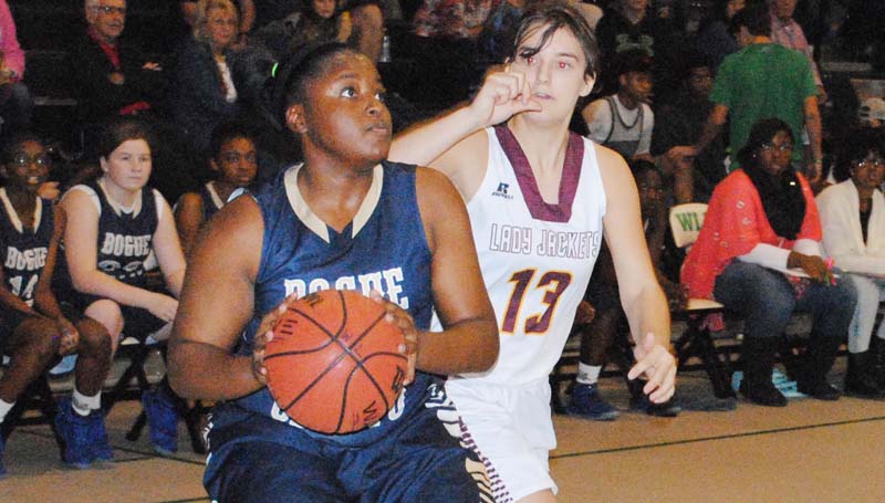 Daily Leader / Marty Albright / Bogue Chitto's Christian Black (21) looks to take a shot Thursday night as Enterprise Michelle Herrington (13) reaches from behind to block the shot.