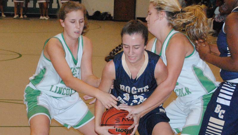 Daily Leader / Marty Albright / Bogue Chitto's Karlie Williams (15) battles to hold on to the ball as West Lincoln's Jana Case and Layton Sills reach in to get a jump ball call Friday night.