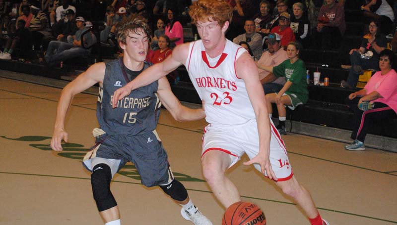 Daily Leader / Marty Albright / Loyd Star's Levi Redd (23) drives to the basket against Enterprise's Zach Hodges (15) Friday night.