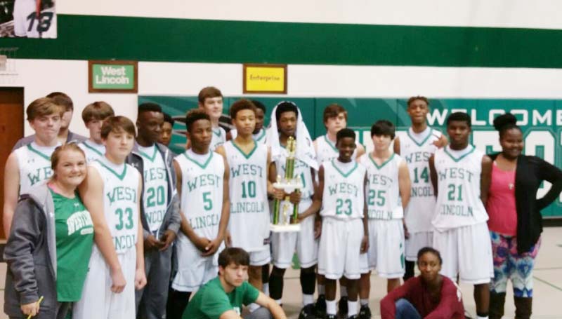 Daily Leader / Photo submitted / West Lincoln coach Lane Young and his Bears won the Lincoln County boys tournament trophy undefeated after defeating the Enterprise Jackets 66-31 Saturday night.