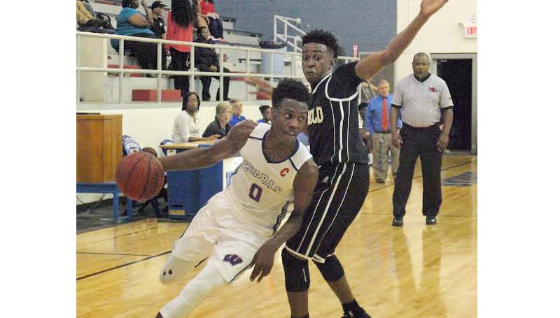 Daily Leader / Tracy Fischer / Wesson's Anthony Jones (0) drives past Bassfield's defender Gerobe Peters (1) in Friday night action at the Snake Pit.