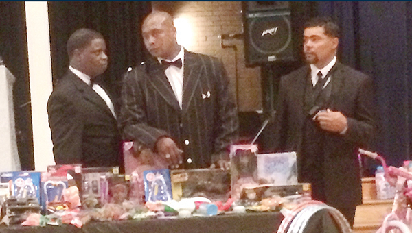 Photo submitted/ Catories Howard, Steve Jones and Andre Spiller sort out Christmas toys for the first annual Christmas banquet held at Lipsey School on Saturday.