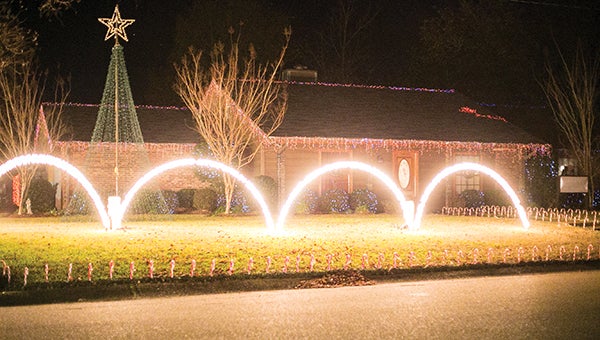 Photo by Kaitlin Mullins/ The synchronized Christmas light display on Tanglewood Drive attracts admirers Monday night. Sunday through Thursday, the lights run from 5:15 until 9:30 p.m. and from 5:15 until 10 p.m. on Fridays and Saturdays.