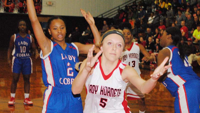 Daily Leader / Marty Albright / Loyd Star's Makenzie Smith (5) reaches to save the ball from going out of bounds, while Wesson's Aurianna Vaughn defends in girls action Tuesday night.