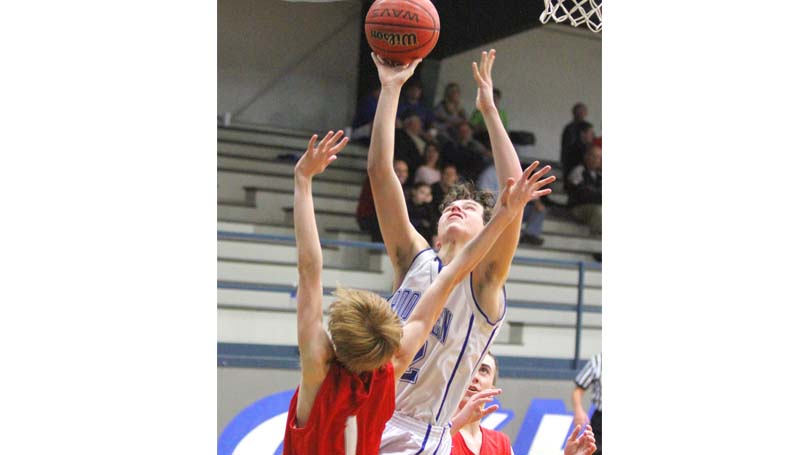 Daily Leader / Sherylyn Evans / Ethan Nations shoots a tough shot against two Parklane defenders Friday night in boys' action at John R. Gray Gymnasium.