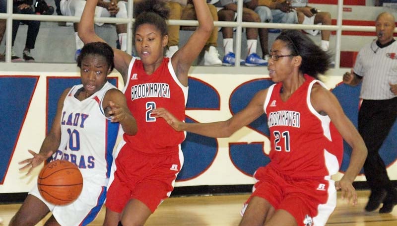Daily Leader / Tracy Fischer / Wesson's Tashay Glasper (10) drives to the basket while being pressured by. Brookhaven's Asia Byrd (2) and Arnancy Arnold (21) Friday night.