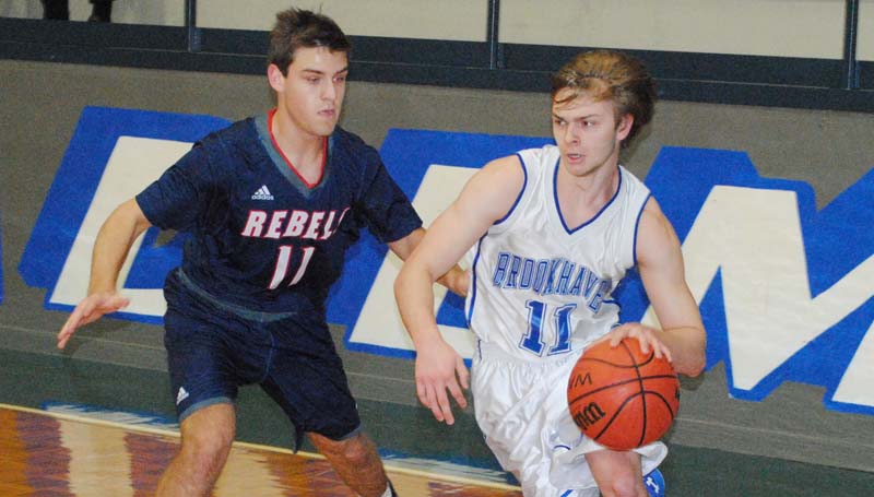 Daily Leader / Marty Albright / Brookhaven Academy's Austin Smith (11) drives the baseline against Tri County's Jake Jones (11) Monday night.