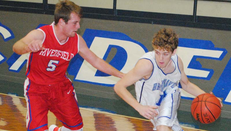 Daily Leader / Marty Albright / Brookhaven Academy's Dylan Winborne (right) drives the baseline in Wednesday night action against Riverfield.