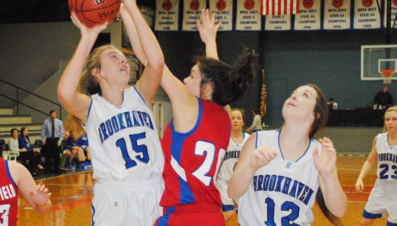 Daily Leader / Marty Albright / Brookhaven Academy's Sissy Byrd (15) is fouled by Riverfield's Leilani Williams (20) while attempting to score a basket in girls' action Wednesday night at John R. Gray Gymnasium.