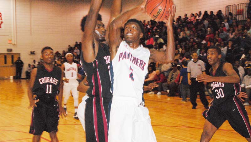 Daily Leader / Marty Albright / Brookhaven Lazorian McNulty (2) powers to the basket to score while Lawrence County's Keyshawn Feazell (22) stretches to deny the attempt Saturday night at Sinclair Gymnasium.