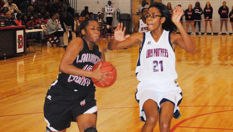 Daily Leader / Marty Albright / Lawrence County's Zipporah Baylis (left) drives to basket to score a layup against Brookhaven's Arnancy Arnold (21) in girls action Saturday night.
