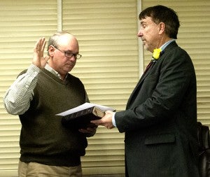 Ricky Welch (left) renews his oath to serve the children of Lincoln County while Superintendent Mickey Myers presides over the proceedings. 