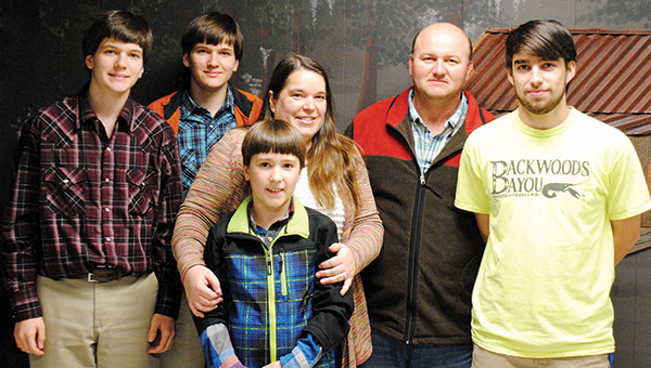 Photo by Aaron Paden / Nathan Lambert, right, poses for a photo with his parents, Amanda and James Lambert, and his three brothers, Nicholas, Noah and Nolan, at Backwoods Bayou where Nathan works after school.