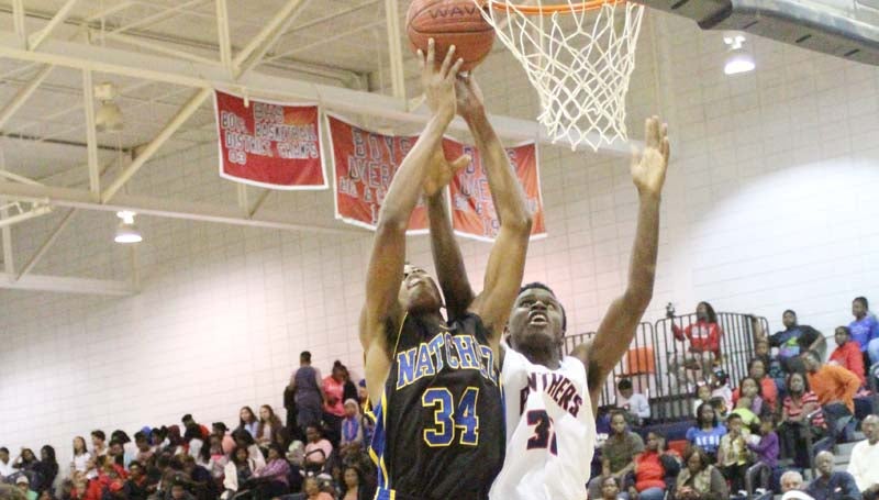 Daily Leader / Patty Emfinger / Brookhaven's Darius Bryant (30) and Natchez's Larry Griffin (34) battles for the rebound in Friday night Region 3-5A action at Sinclair Gymnasium.