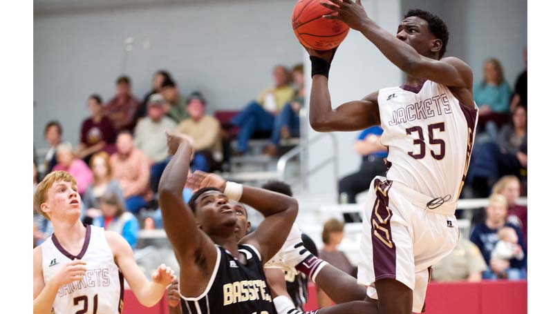 Daily Leader / Teresa Allred / Enterprise's Jontavious Smith (35) scores a tough acrobatic shot over an Bassfield defender Friday night in boys action.