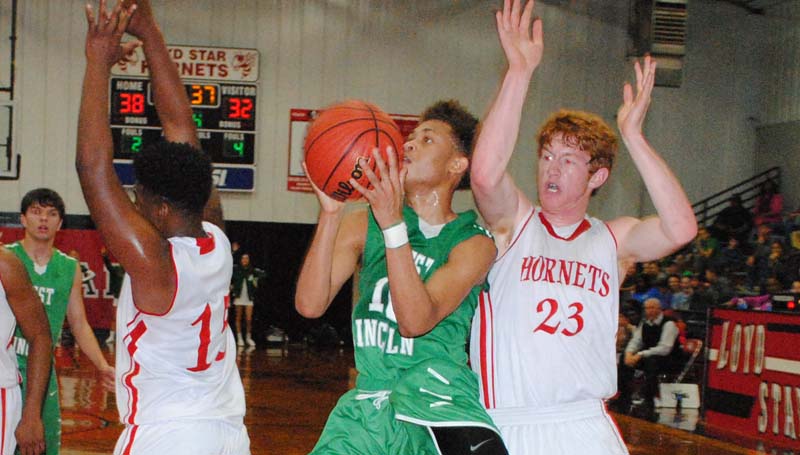 Daily Leader / Marty Albright / West Lincoln's Ronnie Edwards takes a tough shot in between two Loyd Star defenders Avery Leggett (15) and Levi Redd (23) in boys’ action Friday night.