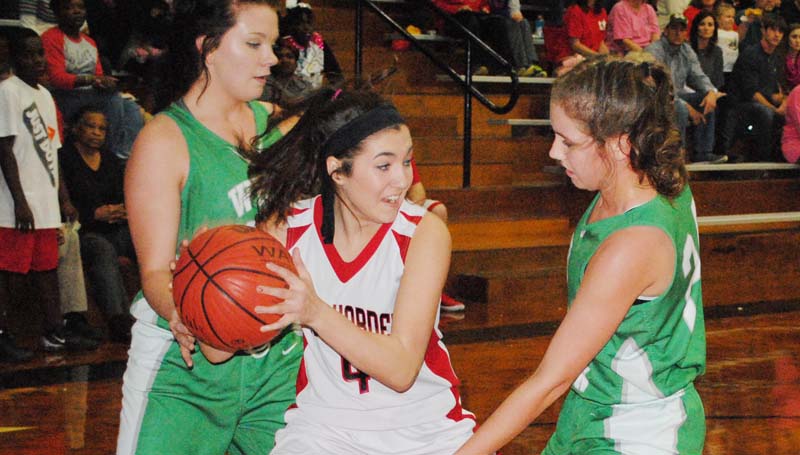Daily Leader / Marty Albright / West Lincoln's Jana Case (24) and Hanna Moak (back) apply defensive pressure on Loyd Star's Caylee Yarborough (4) in girls' action.