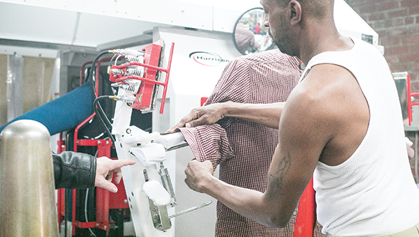 Photo by Kaitlin Mullins / The Unipress Hurricane machine is a fully automated hi-tech shirt pressing machine that can press 120 shirts an hour. It is used at the Patrus dry cleaning location on East Monticello Street.