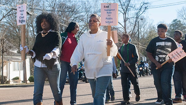 File photo / A group of locals march during last year's Dr. Martin Luther King Jr. parade.