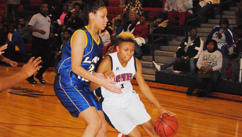 Daily Leader / Marty Albright / Brookhaven's Mya Washington (5) battles to protect the ball against Jefferson County's Antrell Gales in girls' action.