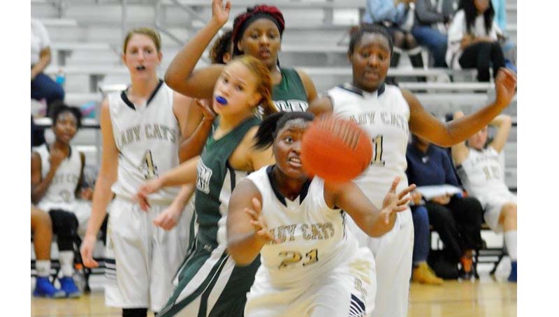 Daily Leader / Stacy Leake / Bogue Chitto's Christian Black (21) reaches for the loose ball in girls action against the Lady Wildcats.