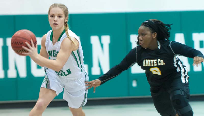 Daily Leader / Teresa Allred / West Lincoln's Carly Holden (left) prepares to pass the ball down the court against Amite County Friday night at Jack Case Gymnasium.