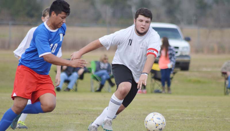 Daily Leader / Chris King / Loyd Star senior captain and midfielder Lane Rogers battles for the ball in boys soccer action Saturday against Forest. The Hornets lost to Forest 4-1.