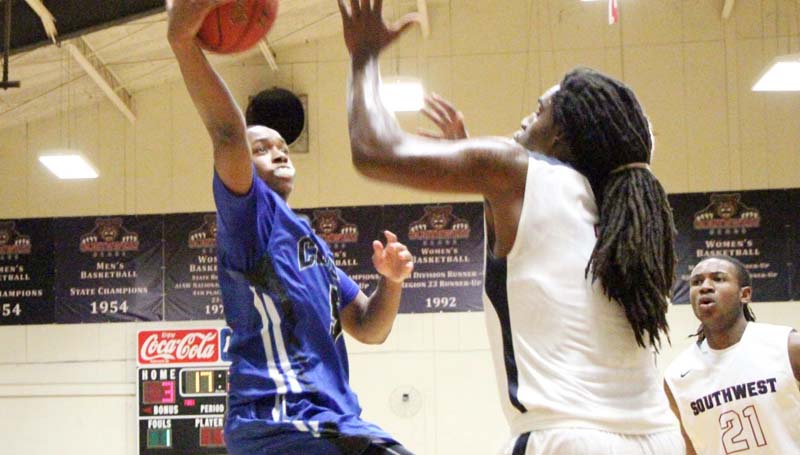 Co-Lin Media / Natalie Davis / Co-Lin's point guard Jonathan Dalton (3) hits the layup over Southwest's LaDerrius Simmons (4) Tuesday night.