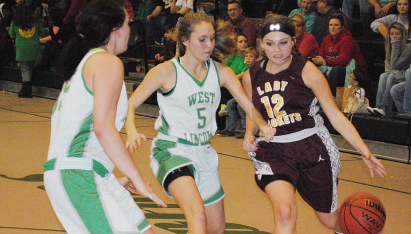 Daily Leader / Marty Albright / Enterprise's Courtney Greer (12) drives to the goal against West Lincoln's defenders Skylar Hall (5) and Hanna Moak (35) Tuesday night.
