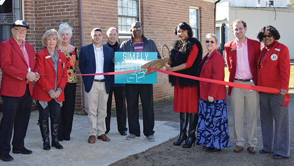 Photo by Regan Barksdale / Shown above is the owner of Simply Beautiful Gift Shop, Linda Williams (holding scissors), her husband, Chester Lee Williams Jr. (holding sign), along with members of the Brookhaven-Lincoln County Chamber of Commerce. Simply Beautiful Gift Shop is located at the back of Shannon’s Hair Creation on Brookhaven Street.