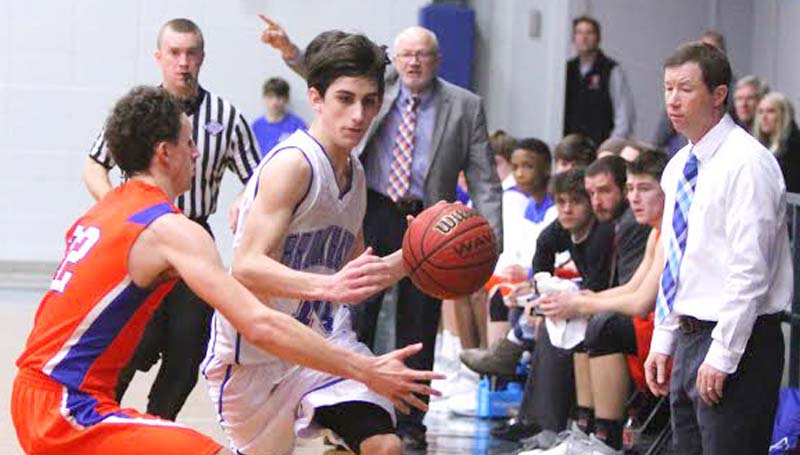 Daily Leader / Sherylyn Evans / Brookhaven Academy's Luke Jackson (10) protects the ball against Columbia Academy's Wiley Cleveland (22) Saturday as Coach Dale Watts and Coach Josh Watts watch closely.