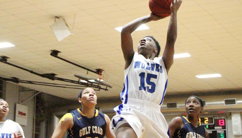 Co-Lin Media / Natalie Davis / Co-Lin's Alexis Collins (15) scores as Gulf Coast's Hayley Pichon (23) and Markeisha Watson (2) look on Monday night.