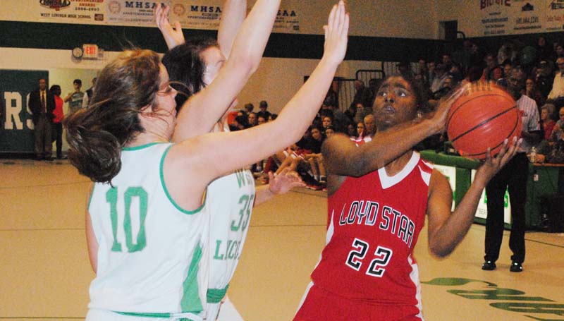 Daily Leader / Marty Albright / Loyd Star's Jordan Shelby (22) looks to score a baskets while being double team by West Lincoln's Hanna Moak (35) and Layton Sills (10).