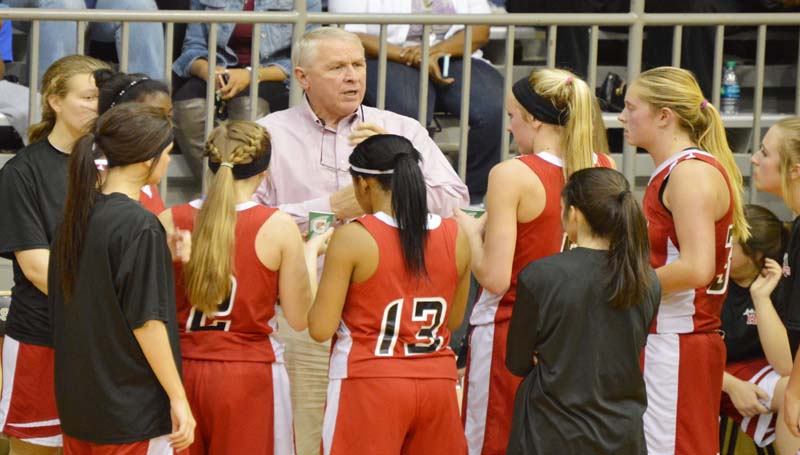 Daily Leader / Chris King / Loyd Star's coach Gene "Moochie" Britt provides instructions to his Lady Hornets during a timeout in girls' action at Bassfield.